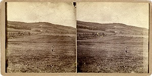 Stereoview of Enfield, NH Shaker Village - Nelson Chase stands in the field between South and Church Family.