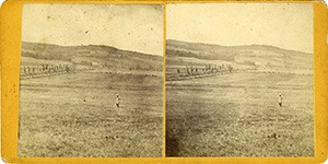 Stereoview of Enfield, NH Shaker Village - Nelson Chase stands in the field between South and Church Family.